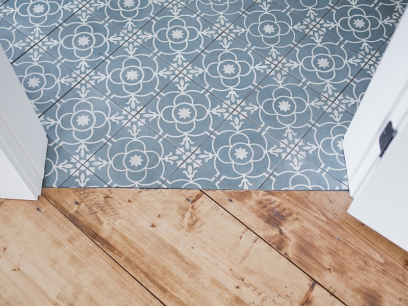 Blue patterned tile floor and hardwood flooring