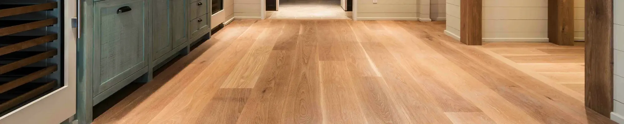 Warm brown hardwood flooring in an open hallway