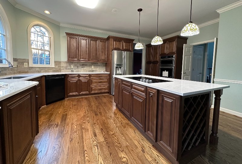 White shaker kitchen remodel wood floor with island