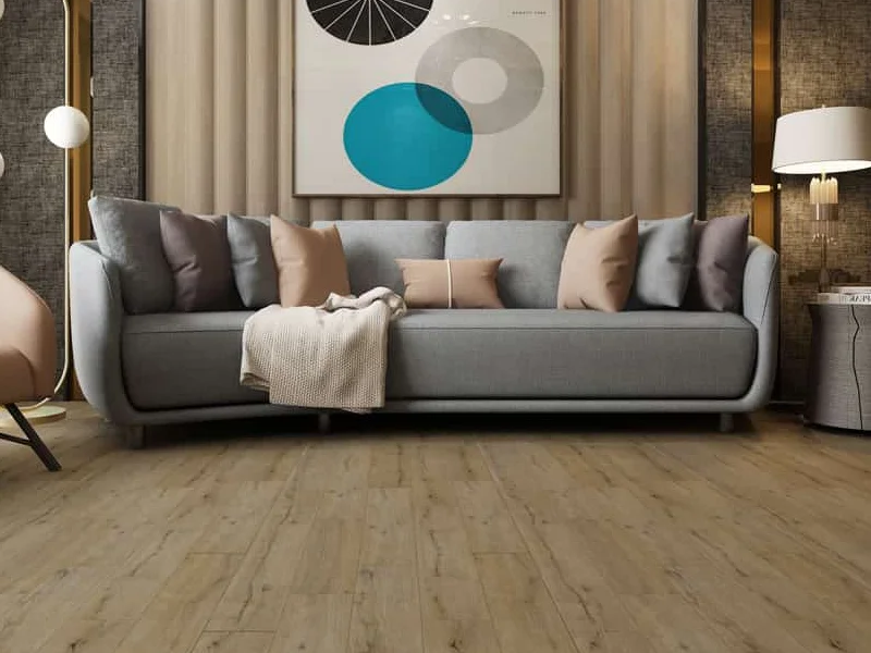 Luxury Vinyl flooring in a living room with a grey sofa and modern wall art